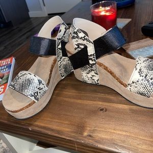 Black and snake skin platforms